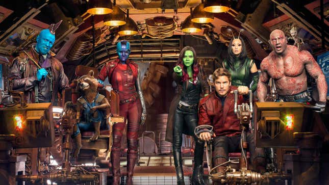 Yondu, Rocket, Nebula, Gamora, Star-Lord, Mantis, Drax, and Baby Groot stare out their spaceship's cockpit window.