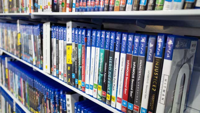 A shelf lined with a bunch of physical copies of video games.