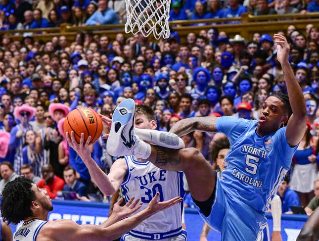 Kyle Filipowski of the Duke Blue Devils battles Armando Bacot of the North Carolina Tar Heels for a rebound during the game at Cameron Indoor Stadium on March 09, 2024 in Durham, North Carolina.The Tar Heels won 84-79. 