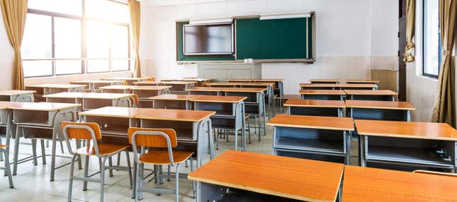 Modern classroom with chairs, desks, and chalkboard.