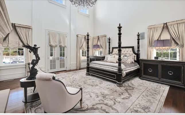 Bedroom with a giant chandelier. 