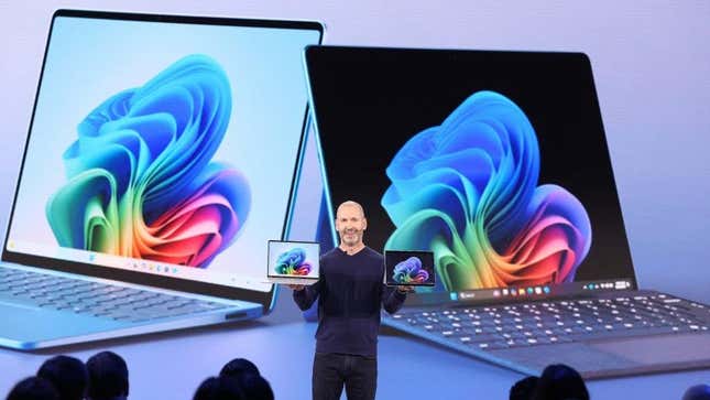 Brett Ostrum of Microsoft showcases two Surface Laptop Go PCs in both hands.