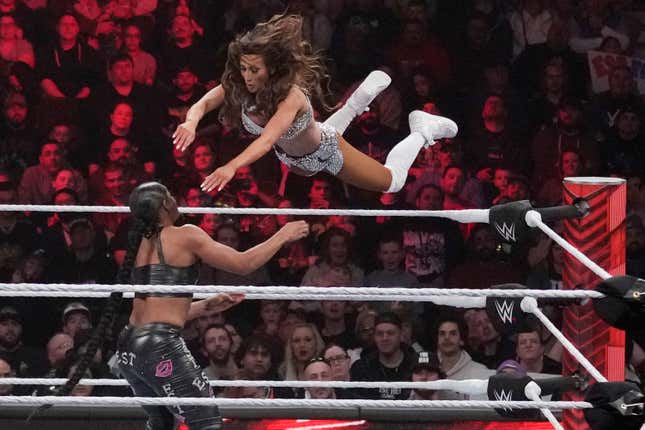 File - Wrestler Carmella leaps at Bianca Belair, during the WWE Monday Night RAW event, March 6, 2023, in Boston. WWE&#39;s weekly television show &quot;Raw&quot; will move to Netflix next year as part of a major streaming deal. (AP Photo/Charles Krupa, File)