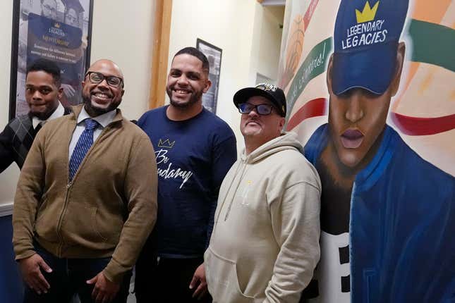 Ron Waddell, Founder and Executive Director of Legendary Legacies, second from left, poses with men benefitting from his nonprofit organization, Friday, April 19, 2024, in Worcester, Mass. Waddell credits Blue Cross Blue Shield volunteers for truly investing in their employee service opportunities, which are increasing across the corporate realm. From left are Antoine Williams, Waddell, Jonathan Maldonado and Gary Goyette. (AP Photo/Charles Krupa)