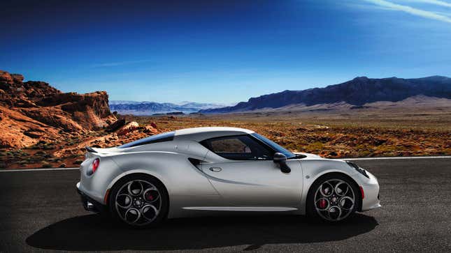 A photo of a silver Alfa Romeo 4C coupe parked in a desert. 