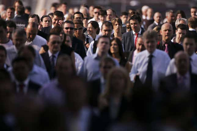 London City workers walk across London bridge.