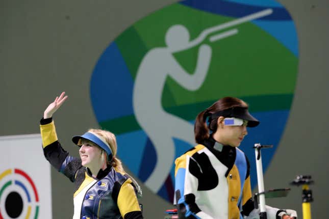 Virginia Thrasher, left, of the United States waves after she won the gold medal for the Women's 10m Air Rifle competition ash runner up Du li, right, of China walks way from the shooting position at Olympic Shooting Center at the 2016 Summer Olympics in Rio de Janeiro, Brazil, Saturday, Aug. 6, 2016.
