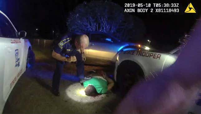 This image from video from Louisiana state police state trooper Dakota DeMoss’ body-worn camera, shows trooper Kory York bending over with his foot on Ronald Greene’s shoulder after he was taken into custody on May 10, 2019, outside of Monroe, La. 