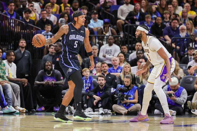 Nov 4, 2023; Orlando, Florida, USA; Orlando Magic forward Paolo Banchero (5) looks to pass against Los Angeles Lakers forward Anthony Davis (3) during the first quarter at Amway Center.