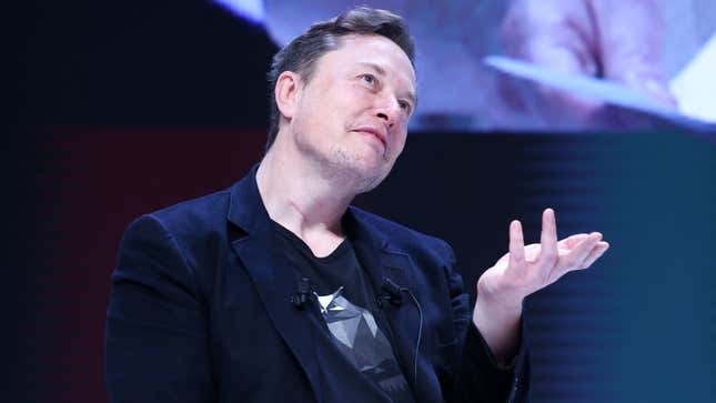 A photo of Elon Musk on stage at an event. 