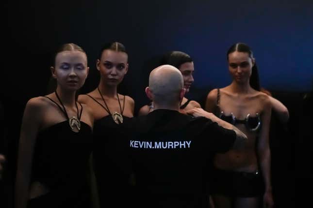 An assistant speak to models backstage prior to presenting the Belgian-Argentine label Sadaels collection in a Parking Gallery at Zaryadye Park near the Kremlin in Moscow, Russia, on Tuesday, Nov. 28, 2023. An international fashion forum in Moscow has brought together designers from Brazil, China, India, South Africa and other countries, an event that underlined Russia&#39;s shift away from the West amid the fighting in Ukraine. (AP Photo/Alexander Zemlianichenko)