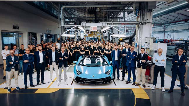 A photo of Lamborghini workers next to the last Aventador