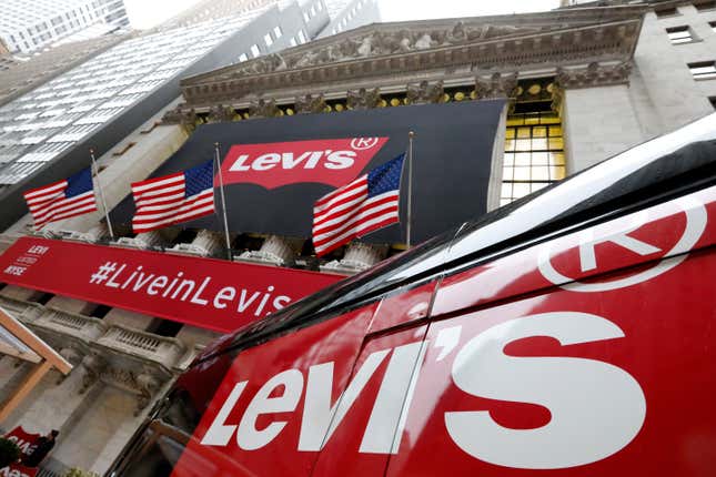 FILE - A Levi&#39;s banner adorns the facade of the New York Stock Exchange, March 21, 2019. Denim giant Levi Strauss &amp; Co. said Thursday, Jan. 25, 2024, that it&#39;s slashing its global corporate workforce by 10% to 15% in the first half of the year as part of a two-year restructuring plan that seeks to simplify its operations. (AP Photo/Richard Drew, File)