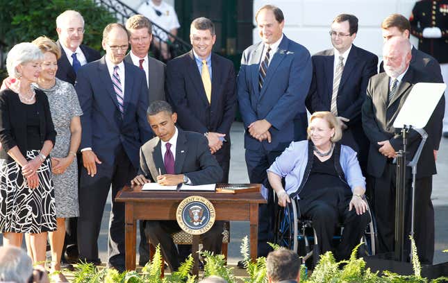 President Barack Obama signs an executive order to increase federal employment of individuals with disabilities at an event marking the 20th anniversary of the Americans with Disabilities Act on the South Lawn of the White House in Washington, Monday, July 26, 2010.