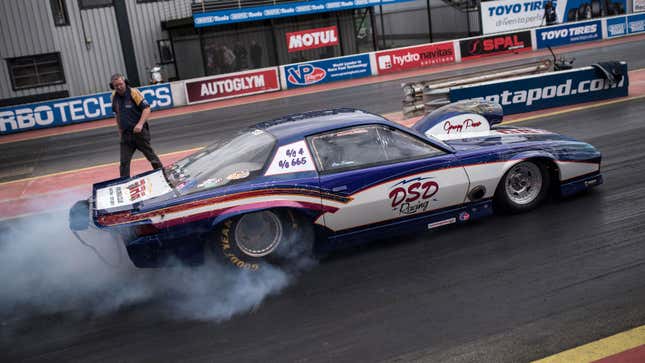 A drag racer pulls away from the start line. 