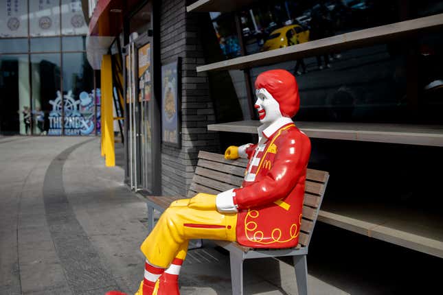 A statue of Ronald McDonald outside a McDonald’s restaurant.