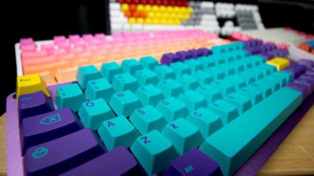 A selection of colorful keyboards, from purple and teal to pink and orange sunset. 