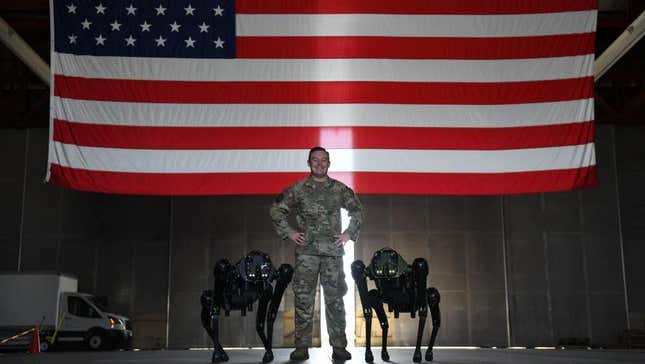 U.S. Air Force Tech Sgt. Brandon Priddy, 45th Security Forces Squadron non-commissioned officer in charge of innovation and technology poses for a picture with Ghost Robotics Vision 60 Quadruped Unmanned Ground Vehicles (Q-UGV) at Cape Canaveral Space Force Station, Fla., July 28, 2022. 