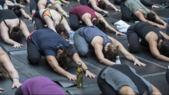 Sydneysiders take part in a mass yoga session on Pitt Street in Sydney's CBD during the evening rush hour on March 20, 2018 in Sydney, Australia.