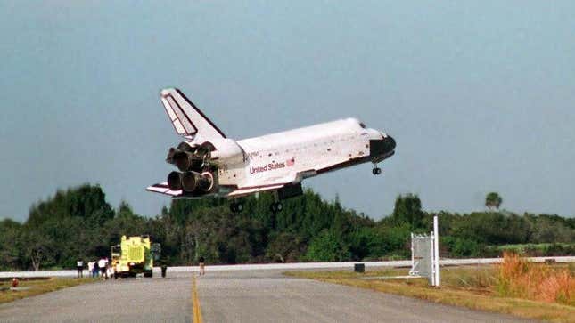 The space shuttle Atlantis glides in for a landing 22 January at Kennedy Space Center in Florida after a ten-day mission in space. The Atlantis and her crew were docked with the Russian space station Mir for five days retrieving US astronaut John Blaha and returning him to Earth after a 118-day stay on the Mir.