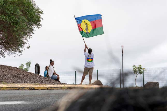Protester holds a New Caledonia territorial flag on May 14, 2024. 
