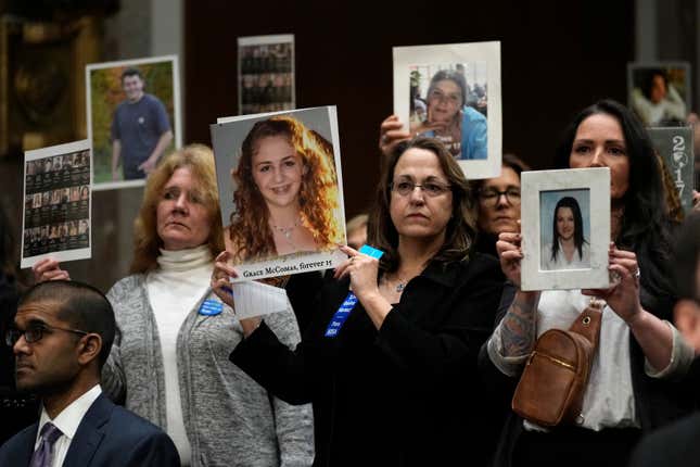 File - People show photos of their loved ones before the start of a Senate Judiciary Committee hearing with the heads of social media platforms on Capitol Hill in Wednesday, Jan. 31, 2024, to discuss child safety. The CEOs got grilled by Senate lawmakers in an emotional and often heated hearing about the dangers their platforms pose to children. (AP Photo/Susan Walsh, File)