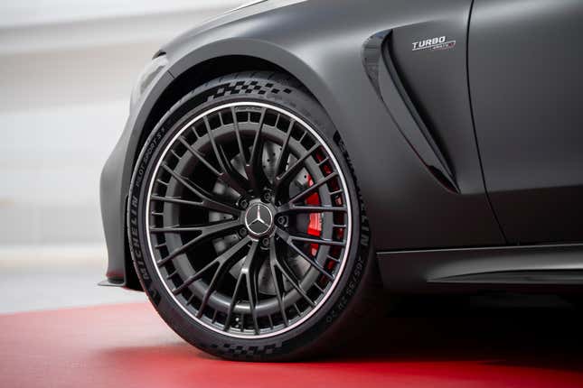 The wheel and front fender of a matte black Mercedes-AMG CLE53 coupe