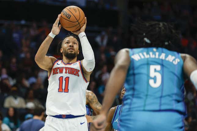 Nov 18, 2023; Charlotte, North Carolina, USA; New York Knicks guard Jalen Brunson (11) shoots the ball over Charlotte Hornets center Mark Williams (5) during the second half at Spectrum Center.