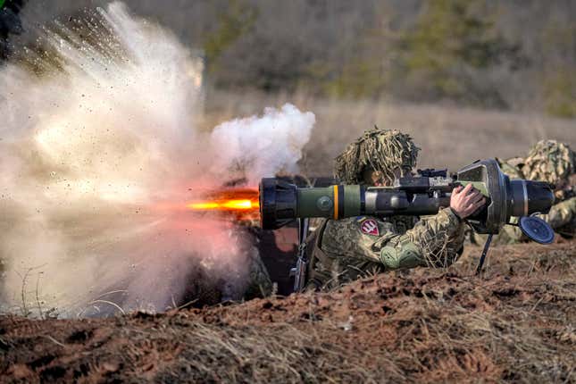 FILE - A Ukrainian serviceman fires an NLAW anti-tank weapon during an exercise in the Joint Forces Operation, in the Donetsk region, eastern Ukraine, Feb. 15, 2022. An independent watchdog says many Western arms companies failed to ramp up production in 2022 despite a strong increase in demand for weapons and military equipment. Labor shortages, soaring costs and supply chain disruptions were exacerbated by Russia’s invasion of Ukraine, according to the Stockholm International Peace Research Institute, or SIPRI. It said the arms revenue of the world’s 100 largest arms-producing and military services companies last year was $597 billion — a 3.5% drop from 2021. (AP Photo/Vadim Ghirda, File)