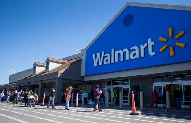 A line forms outside of the Walmart in Quincy, MA on April 4, 2020. 