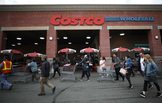 People walk to enter a Costco Wholesale in Glendale, California.