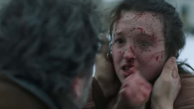 Joel tries to console Ellie as her face is covered in blood.