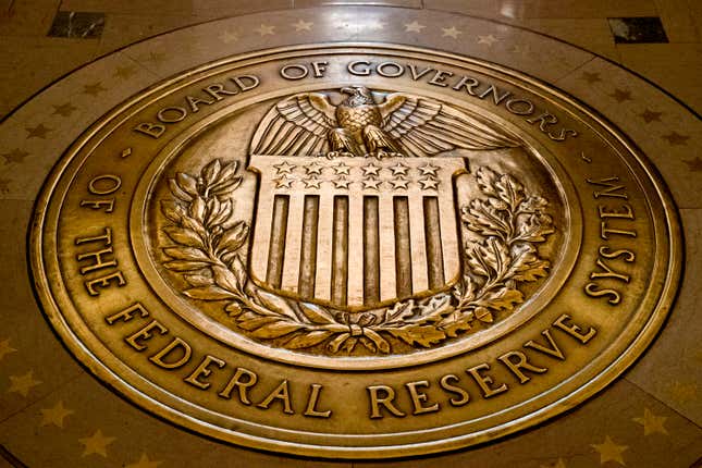 FILE- In this Feb. 5, 2018, file photo, the seal of the Board of Governors of the United States Federal Reserve System is displayed in the ground at the Marriner S. Eccles Federal Reserve Board Building in Washington. (AP Photo/Andrew Harnik, File)