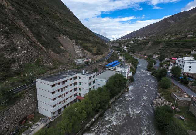 A bitcoin “mine” with a blue tin roof sits next to a hydroelectric power plant in Ngawa Tibetan and Qiang Autonomous Prefecture, Sichuan province.
