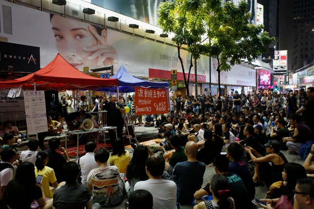 A "mobile democracy classroom" lecture is held as protesters occupy a main road for the third day at Causeway Bay shopping district in Hong Kong October 1, 2014.