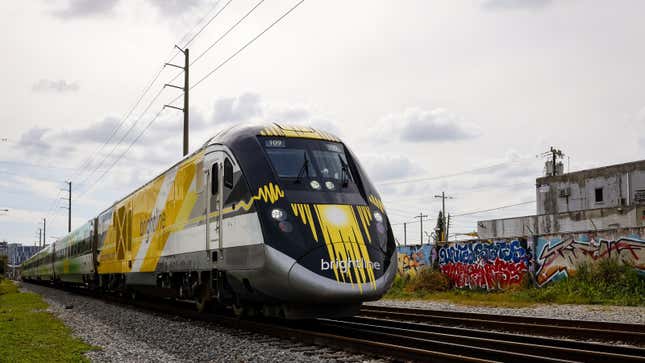 A photo of a Brightline train on the tracks in Florida. 