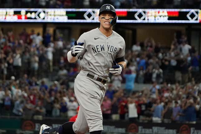 New York Yankees’ Aaron Judge gestures as he runs the bases after hitting a solo home run, his 62nd of the season, during the first inning in the second baseball game of a doubleheader against the Texas Rangers in Arlington, Texas, Tuesday, Oct. 4, 2022. 