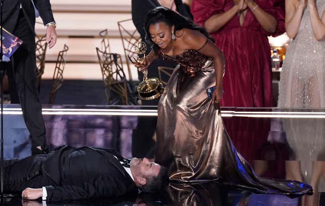 Quinta Brunson, winner of the Emmy for outstanding writing for a comedy series for “Abbott Elementary”, checks on Jimmy Kimmel as he lays on stage at the 74th Primetime Emmy Awards on Monday, Sept. 12, 2022, at the Microsoft Theater in Los Angeles.