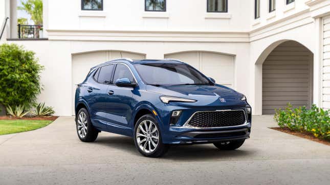 A blue Buick Encore GX parked in front of a white house