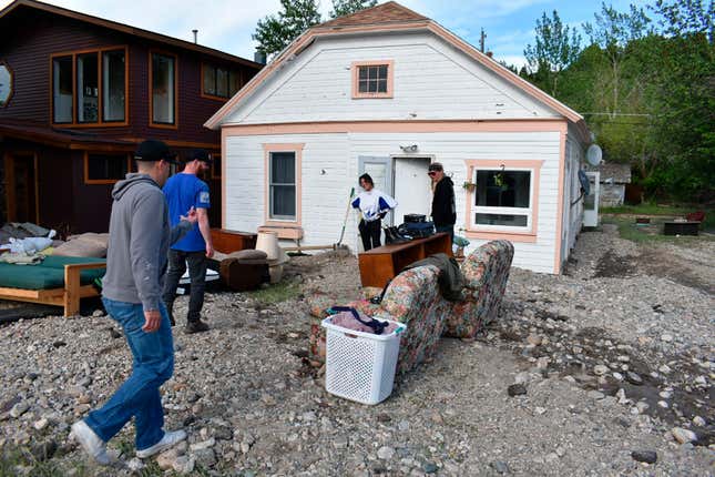 Residents of Red Lodge, Mont., inspect damage to a house that was  flooded after torrential rains fell across the Yellowstone region,  Tuesday, June 14, 2022. 