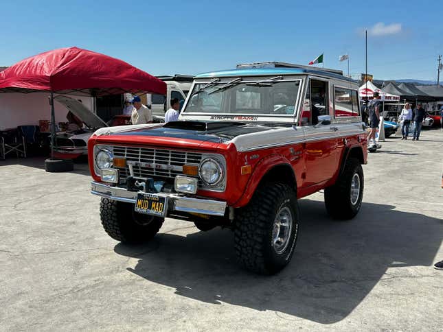 A classic Ford Bronco outfitted for desert racing is in the pits at Laguna Seca