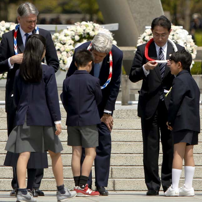 Children give lei necklaces to G7 foreign ministers who visited Hiroshima.