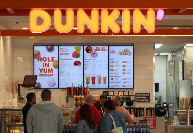 People line up at a Dunkin’ store inside Terminal A at Newark Liberty International Airport. 