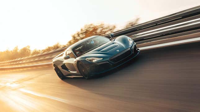 A Rimac Nevera driving up against the guardrail at the top of a banked test track