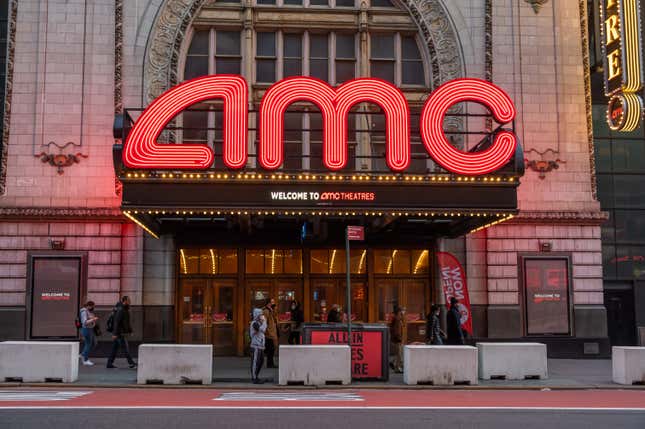  People walk outside the AMC Empire 25 movie theater in Times Square.