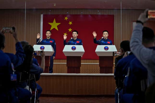 Chinese astronauts for the upcoming Shenzhou-17 mission, from left, Jiang Xinlin, Tang Hongbo, and Tang Shengjie wave as they arrive for a meeting with the press at the Jiuquan Satellite Launch Center in northwest China, Wednesday, Oct. 25, 2023. (AP Photo/Andy Wong)