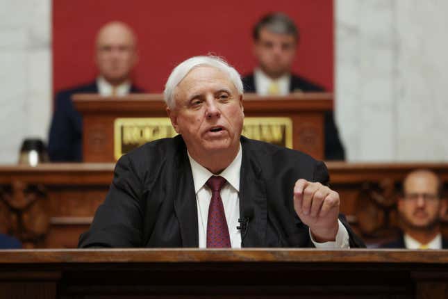 FILE - West Virginia Gov. Jim Justice delivers his annual State of the State address in the House Chambers of the state Capitol, Jan. 11, 2023, in Charleston, W.Va. Justice signed a bill Friday, March 22, 2024, that would ban smoking in cars with children present. West Virginia has the highest rate of adult cigarette use in the nation. (AP Photo/Chris Jackson, File)