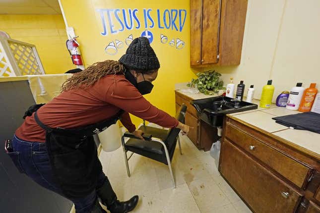 Belinda Smith, owner of Styles of Essence, a hair salon in south Jackson, Miss., points out the gallons of water stored under each sink, available to use for rinsing clients hair because of the uncertainty of the city’s water service, Wednesday, Jan. 26, 2022. The city’s ongoing water woes sometimes requires the area water to be shut off without warning.