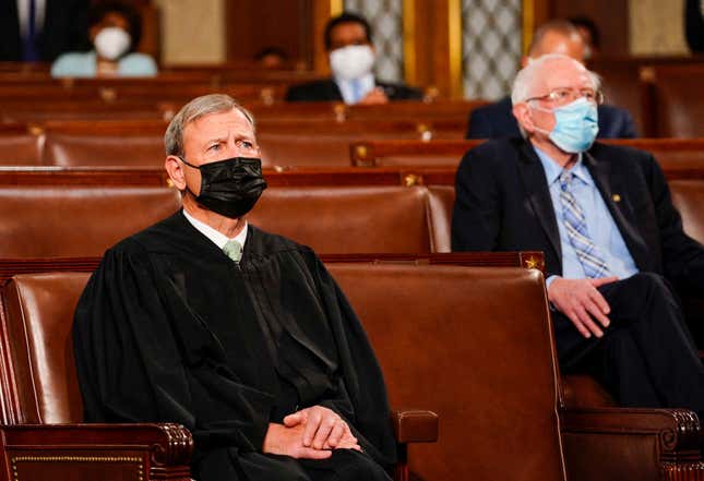 Chief Justice John G. Roberts Jr. (L) and Sen. Bernie Sanders (I-VT) listen as US President Joe Biden addresses a joint session of Congress at the US Capitol in Washington, DC, on April 28, 2021. 