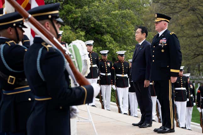 Japan&#39;s Prime Minister Fumio Kishida, with Commanding General Military District of Washington Maj. Gen. Trevor Bredenkamp, right, stands at attention during a wreath laying ceremony at the Tomb of the Unknown Soldier, at Arlington National Cemetery, in Arlington, Va., Tuesday, April 9, 2024. (AP Photo/Manuel Balce Ceneta)